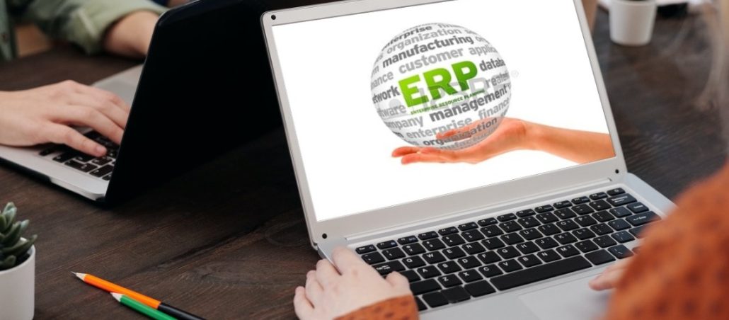 Woman working on a computer with ERP's logo